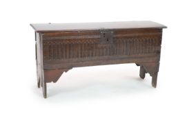 A 17th century oak six-plank chestwith carved front and plain sidesH 64cm. W 124cm. D 38cm.