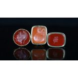 Three assorted gold overlaid and carnelian set fob seals,the matrix carved with crested initials,