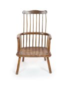 An 18th century West Country elm and fruitwood primitive armchairwith comb back and saddle seatH