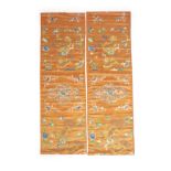 A pair of Chinese peach silk embroidered hangings, 19th centuryeach embroidered with Buddhist lions