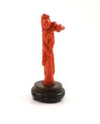 A Chinese coral figure of a tall lady holding a Lotus sprig, mid 20th century11.1 cm high, 59g,