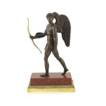 A 19th century bronze figure of Eros,standing holding an ormolu bow, on rouge marble and ormolu