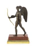 A 19th century bronze figure of Eros,standing holding an ormolu bow, on rouge marble and ormolu