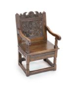 A South Lancashire/North Cheshire Charles II carved and panelled oak open armchairwith flowers and