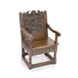 A South Lancashire/North Cheshire Charles II carved and panelled oak open armchairwith flowers and