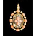 A Victorian gold, coral, seed pearl and diamond set rock crystal oval pendant,with central star