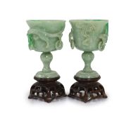 A pair of Chinese small jadeite stem cups, 20th century,each carved in high relief with a chi