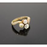 An Edwardian 18ct gold and three stone set clover shaped cluster ring,with graduated diamond set