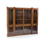 A Regency style mahogany inverse breakfront bookcasewith gilt brass mounts and for glazed board