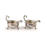 A pair of George II silver sauceboats, by Henry Brind,with flying scroll handles, on hoof feet,