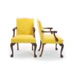 A pair of George II style mahogany elbow chairs,with yellow fabric upholstered backs and seats, and