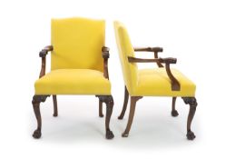 A pair of George II style mahogany elbow chairs,with yellow fabric upholstered backs and seats, and