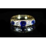 An early 20th century three stone sapphire and two stone diamond set half hoop ring,with diamond