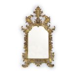 An 18th century Florentine giltwood wall mirror,with central broken arch mask and plume crest and