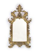 An 18th century Florentine giltwood wall mirror,with central broken arch mask and plume crest and