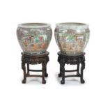 A pair of Chinese famille rose ‘goldfish’ bowls,decorated with figures amid pavilions and trees,