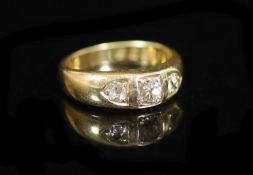 A George V 18ct gold and three stone diamond ring,set with old mine cut stones, the largest