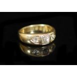 A George V 18ct gold and three stone diamond ring,set with old mine cut stones, the largest