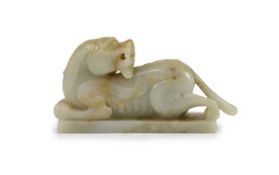 A Chinese Ming archaistic pale celadon and russet jade figure of a pixiu, 16th/17th century,on an