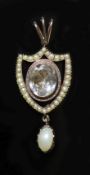 An early 19th century gold rock crystal, baroque and seed pearl set shield shaped drop pendant,