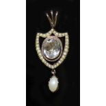 An early 19th century gold rock crystal, baroque and seed pearl set shield shaped drop pendant,