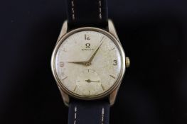 A gentleman's early 1960's 9ct gold Omega manual wind wrist watch,with quarterly Arabic numerals