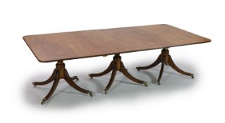 A Regency and later mahogany triple pedestal dining table,with reeded rounded rectangular top and