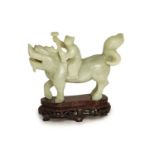 A Chinese pale celadon-grey jade group of a boy riding a qilin, 17th/18th century,13.5cm long, wood