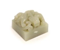 A Chinese pale grey jade ‘chilong’ seal,carved in high relief and openwork with a scrawling Chi-