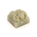 A Chinese pale grey jade ‘chilong’ seal,carved in high relief and openwork with a scrawling Chi-