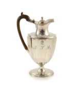 A George III silver hot water ewer, William Sumner I?,of panelled vase shape, with engraved initial