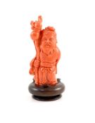 A Chinese coral standing figure of Shou Lao, mid 20th century,11 cm high, 187g, wood stand