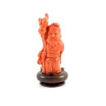 A Chinese coral standing figure of Shou Lao, mid 20th century,11 cm high, 187g, wood stand