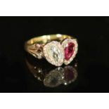 A 19th century gold two stone pear cut ruby and diamond set ring,with rose cut diamond set borders,