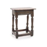 A Charles I oak joint stool,with lunette-carved frieze on turned tapered legs with leafy capitals,H