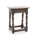 A Charles I oak joint stool,with lunette-carved frieze on turned tapered legs with leafy capitals,H