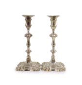 A pair of early George III cast silver candlesticks by William Cafe,with waisted knopped stems, on