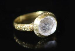 An early George I engraved gold, rock crystal and two colour enamel set memento mori ring,the