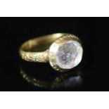 An early George I engraved gold, rock crystal and two colour enamel set memento mori ring,the