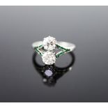 A 1920's platinum and two stone diamond ring,with emerald set split shoulders, size L, gross weight