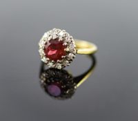 A modern 18ct gold, deep pink tourmaline and diamond set oval cluster ring,size J, gross weight 3.9
