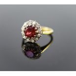 A modern 18ct gold, deep pink tourmaline and diamond set oval cluster ring,size J, gross weight 3.9