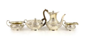 An Edwardian embossed silver circular four piece tea and coffee service by Edward Barnard & Sons