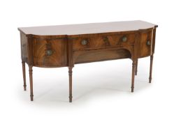 A large George III mahogany breakfront sideboard,with two central drawers flanked by a cupboard and