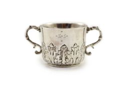 A William III repousse silver porringer, by Jonah Kirk, London c.1695,with typical acanthus leaf