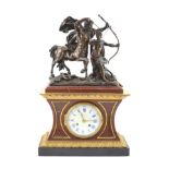 A late 19th century French bronze mounted rouge marble mantel clock,surmounted with a figural