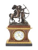 A late 19th century French bronze mounted rouge marble mantel clock,surmounted with a figural