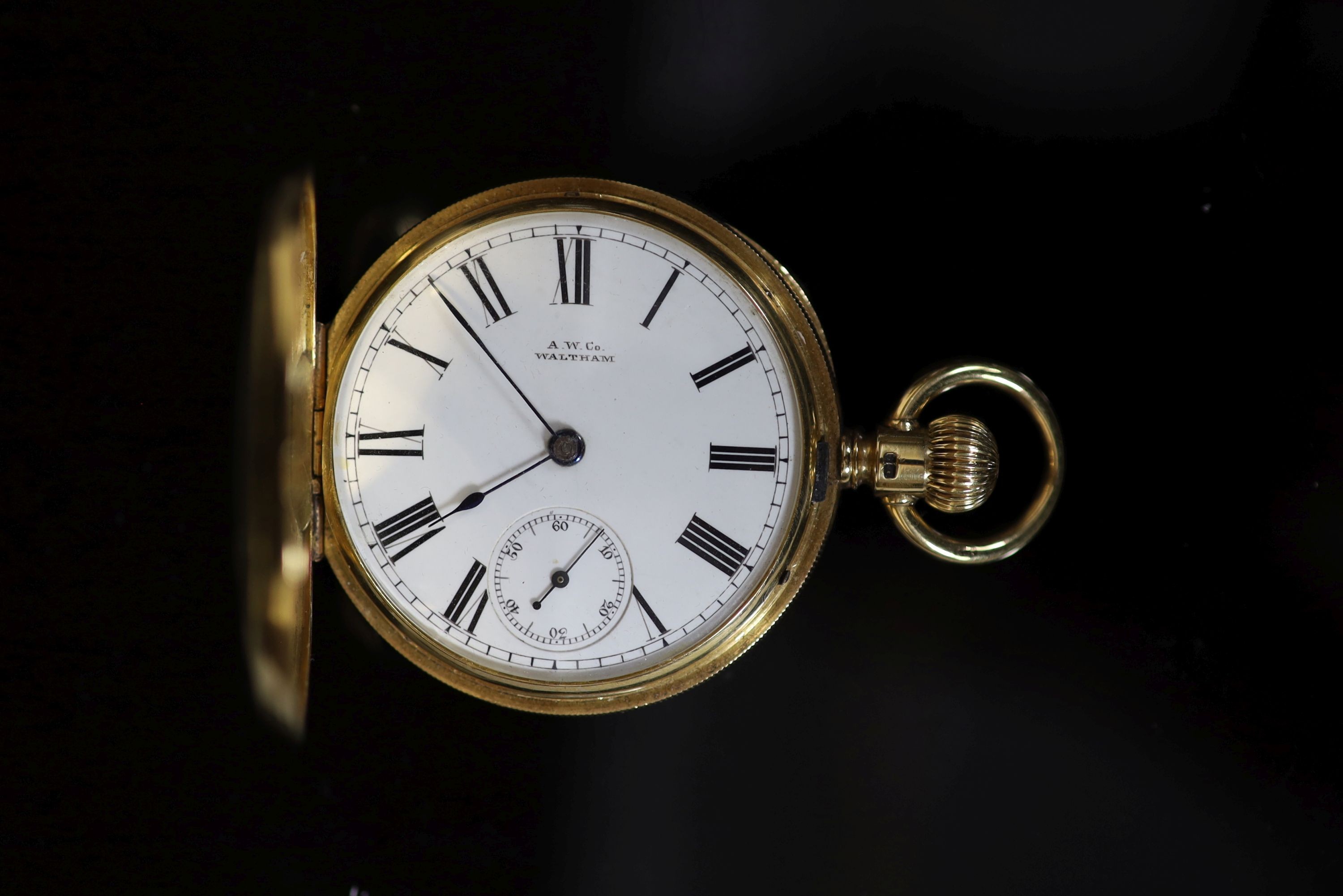 A late Victorian engine turned 18ct gold A W. Co Waltham hunter keyless lever pocket watch,with