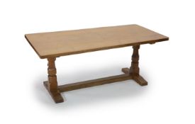 A Robert Thompson Mouseman adzed oak refectory table,with rounded rectangular top on octagonal