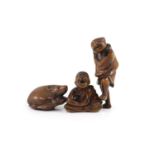 Three Japanese boxwood netsuke, 19th century,the first in the form of a rat eating a seedpod,